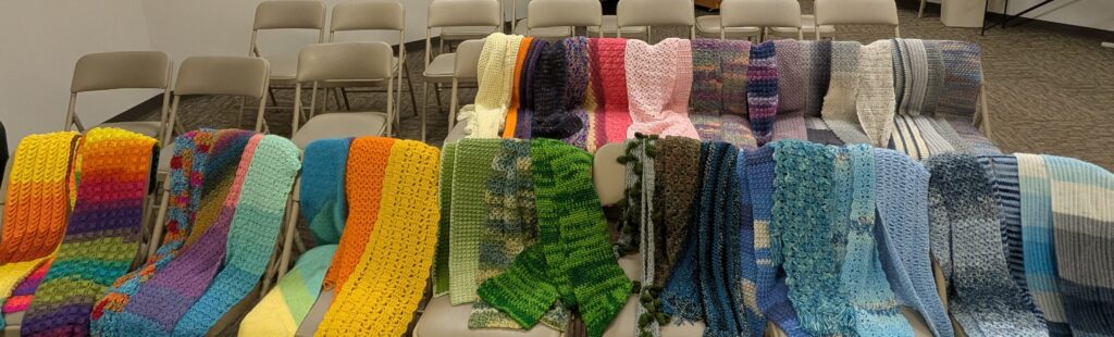 photo of colorful scarves draped over folding chairs